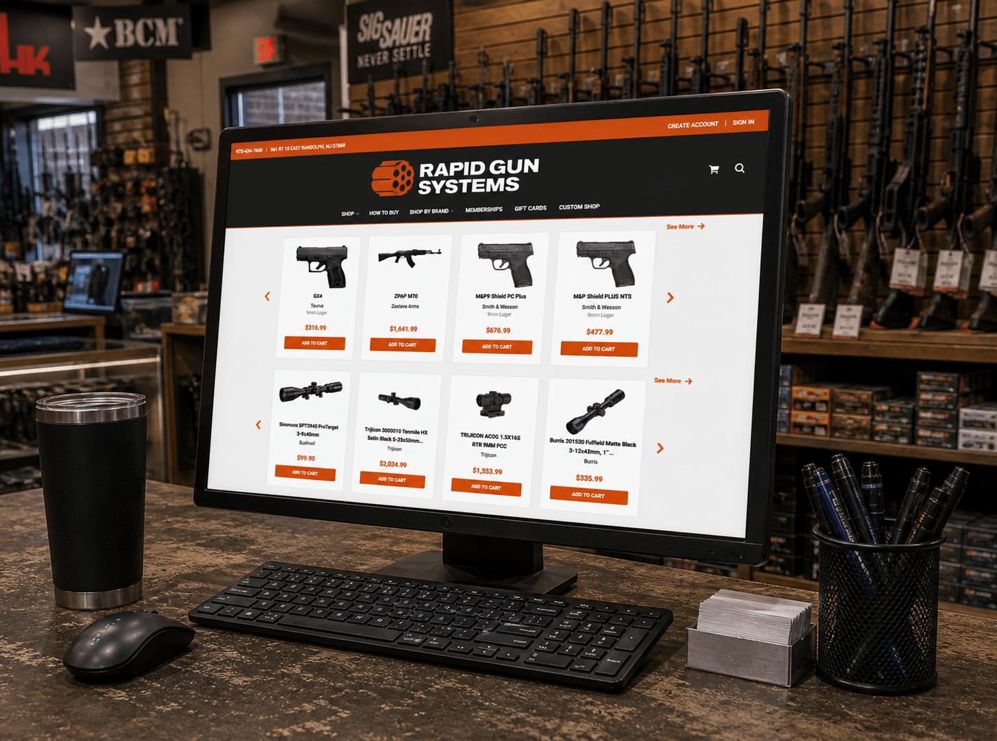 A gun shop counter displays Rapid Gun Systems ecommerce on a computer, showcasing ecommerce integration with firearms and accessories.